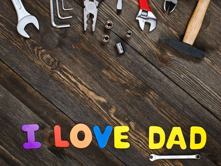 I love Dad. Letters and tools on a wooden background.の写真素材