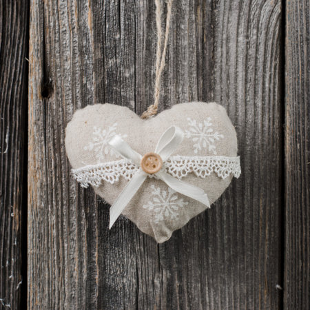 Christmas decoration over wooden background. soft heart on a rope