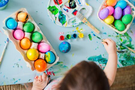 Baby Painting Easter Eggsの写真素材