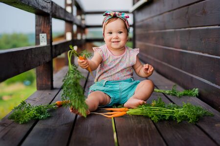 Baby and carrotsの写真素材