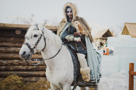Russia. Moscow.Red square 26 Feb 2017. Carnival Maslenica . warrior winter sitting on a horse and holds her hand on the owlのeditorial素材