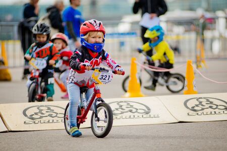 Russia, Moscow, Gorky Park, September 09, 2017. Childrens bike ride. Children from 2 years to 7 in helmets compete in bike races, balance bike, run bikeのeditorial素材