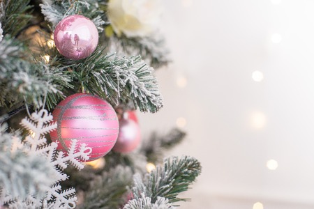 Decorated in a pink Christmas tree on a blurred, sparkling and fabulous background. Free space for text and greetings. New Year.の写真素材