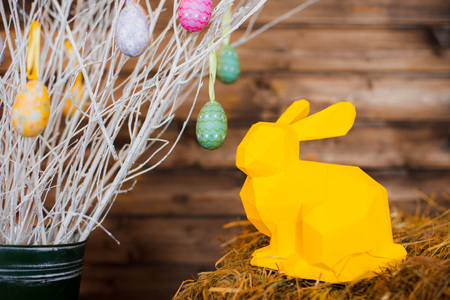 Easter, Easter painted eggs, with Easter hares. Paper scenery on wooden background. Holiday cardの写真素材