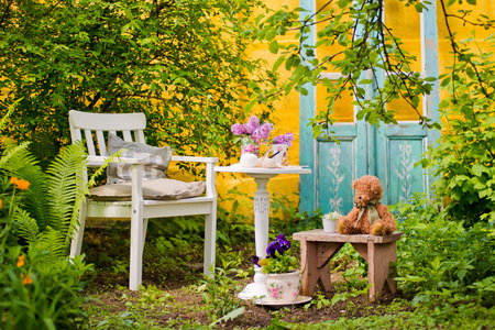 White wooden chair table with a bouquet of lilacs in the spring garden. Recreation area in the shade of trees own garden. Relax in nature. Clean air, peace for creativity and inspiration. fern, appleの写真素材