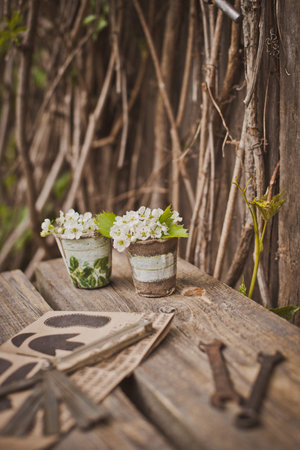 design of the photo zone in a rustic style, old wooden doors and boards with tools and spring...