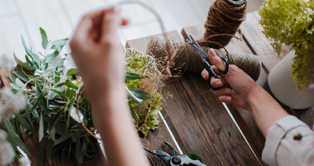Womens girl strikes up a professional florist bouquet. Flower shop. Concept inspiration, floristry,...