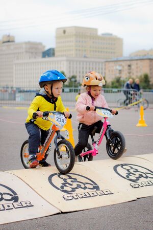Russia, Moscow, Gorky Park, September 09, 2017. Children's bike ride. Children from 2 years to 7 in helmets compete in bike races, balance bike, run bikeのeditorial素材