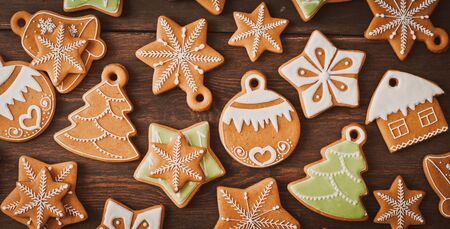 festive Christmas gingerbread cookies in the shape of a star lie on a wooden dark brown background. background new yearの写真素材