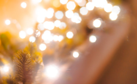 fur-tree branch with decorative lights bokeh defocused festive Christmas background