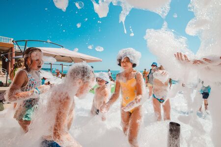 Russia, Tuapse July 4, 2019: foam party. Children and adults have fun at a foam party on the beach.のeditorial素材
