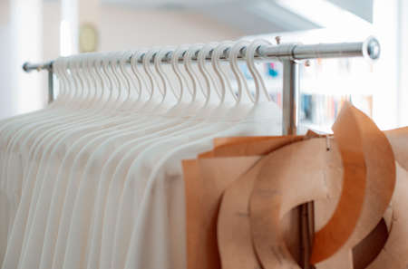 industrial production of clothing, a large number of paper sewing designs hanging barbell. Patterns for sewing atelier clothing workshopの写真素材