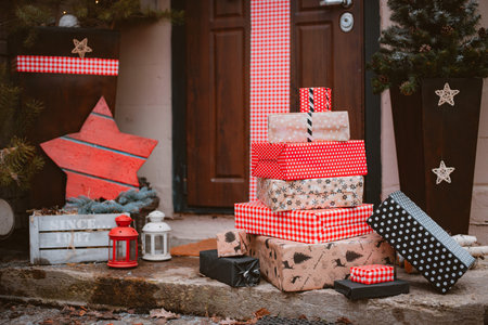Christmas decoration of the porch of the house. The entrance door is decorated with a large red bow.