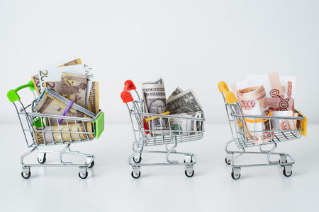 Dollars, rubles, euros in a shopping cart on a white table background. The concept of price currency exchange rate difference. ruble against the dollarの写真素材