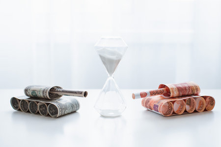 tank of dollar and ruble banknotes on a white table background. bills. The concept of arms supply,...