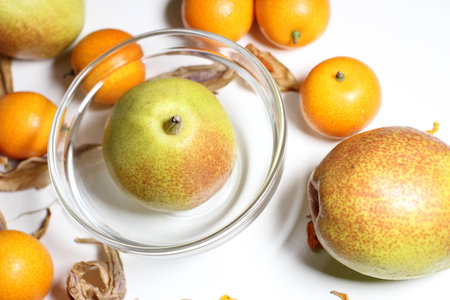 Fruits of pear and kumquatの写真素材