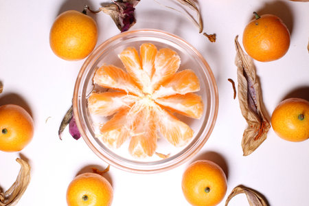 Orange kumquat fruit in glass bowlの写真素材