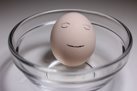 hand draw the sleeping face on egg の写真素材
