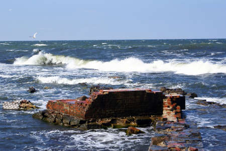 Old brick wall in the water, Baltic sea coast, Russia                    の写真素材