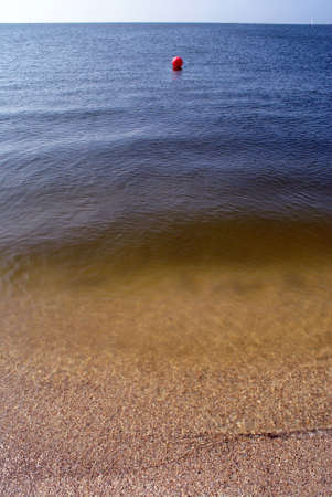 Red ball on the sea, Azov sea coast, south Russia                    の写真素材