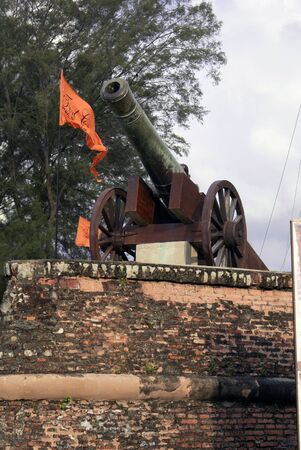 Flag, gun and brick wall, fort Penang, Malaysia                 の写真素材