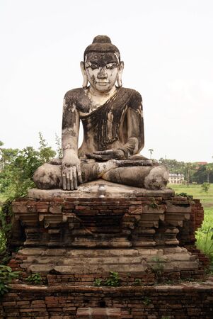 Sitting Buddha on the brick wall in Inwa, Mandalay, Myanmar               の写真素材
