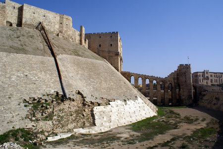 Wide moat and citadel on the hill in Aleppo, Syria                   