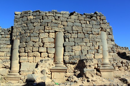 Stone basalt wall and columns on the street of Old Bosra, Syriaの写真素材