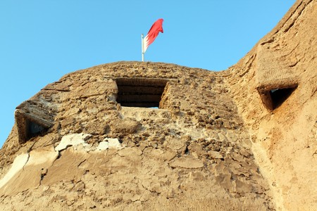 Flag and wall of fort Arad in Manama city, Bahreinの写真素材