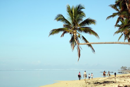 People on the horseback on the beach in Fijiの写真素材