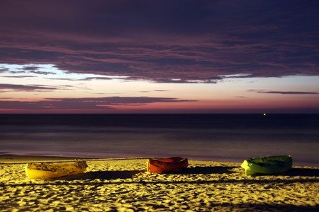 Boats on the beach at night in Mancora, Peruの写真素材