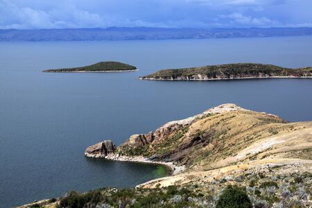 Small island on lake Titicaca and coast of island Isla del Solの写真素材