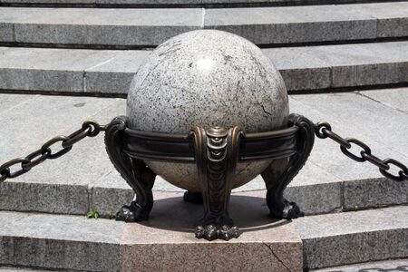 Marble ball and bronze chain near the monumentの写真素材