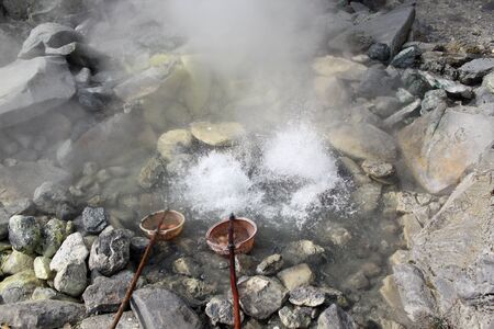 Boiling eggs in basket in hot springs in volcano Prabhupan Perahu near Bandungの写真素材
