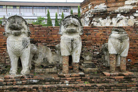 Stone lions and basement of brick stupa in Wat Thummikarat, Ayutthaya, Thailand のeditorial素材