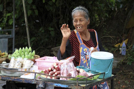 Old woman and fruit stall on the street in Ayutthaya, Thailandのeditorial素材