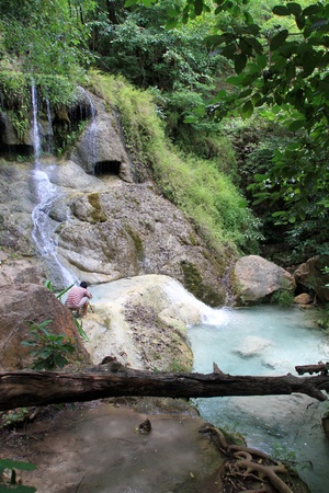 Photographer on the rock near waterfall Erawan, Thailandのeditorial素材