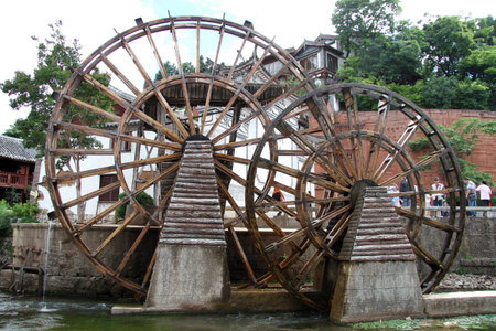 Two big wooden wheels on the square in Lijiang, China