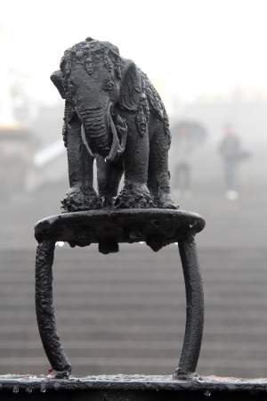 Sculpture of wet black elephant on the top of buddhist shrine in Chinaの写真素材