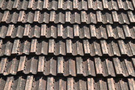 Very old dirty clay tile roof of house