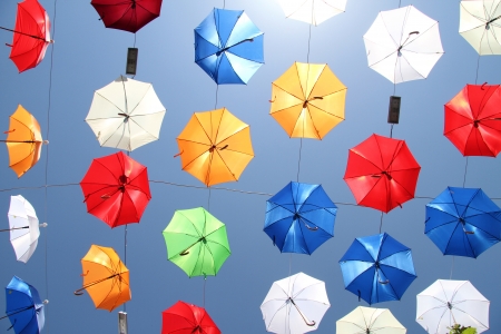 A lot of color umbrellas on the skyの写真素材