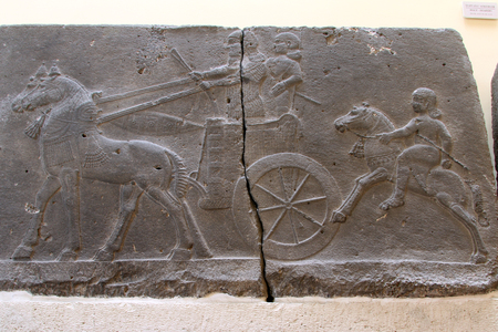 Warriors with chariot on the bas-relief on the sandstone in Archeological museum in Istanbulの写真素材