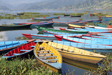 Bright color wooden boats on the Phewa lake in Pokhara, Nepalのeditorial素材