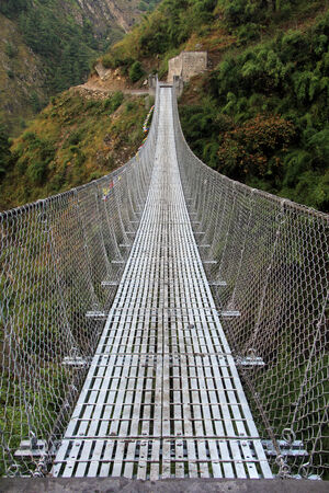 Suspension bridge and mountain in Nepalの写真素材