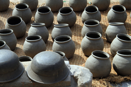 Row of pots on the straw mat on the ground in Bhaktapur, Nepalの写真素材