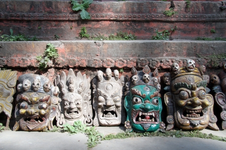 Traditional masks near wall of temple on the Durbar square in Khatmandu, Nepal の写真素材