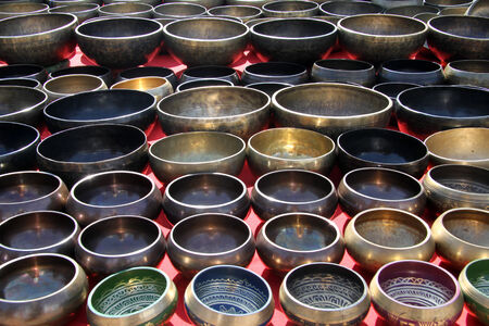 A lot of buddhist bronze bowls on the stall for sell in Khatmandu, Nepalの写真素材
