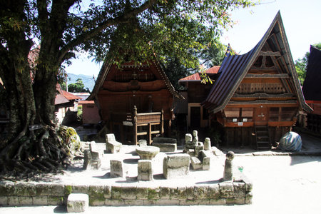 Stone chairs near houses in Ambarita village, Indonesiaのeditorial素材
