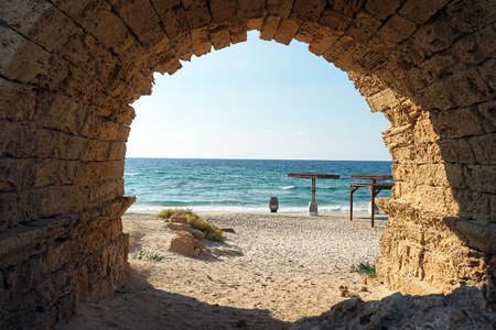 Entrance to the sand beach through the arch of aqueduct near Caesarea, Israeklの写真素材