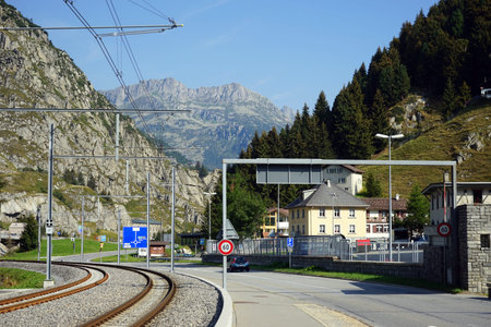 ANDERMATT, SWITZERLAND - CIRCA AUGUST 2015 Railroad and highwayのeditorial素材